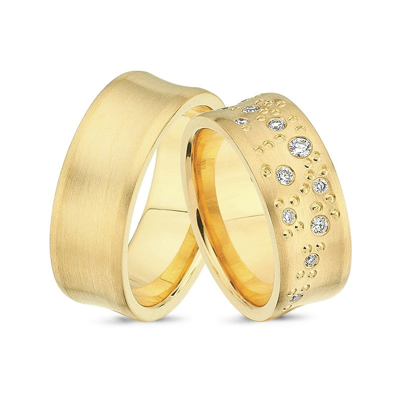 Brede Nuran vielsesringe i 14 karat guld med silkemat finish og 0,18 ct diamanter på dameringen.